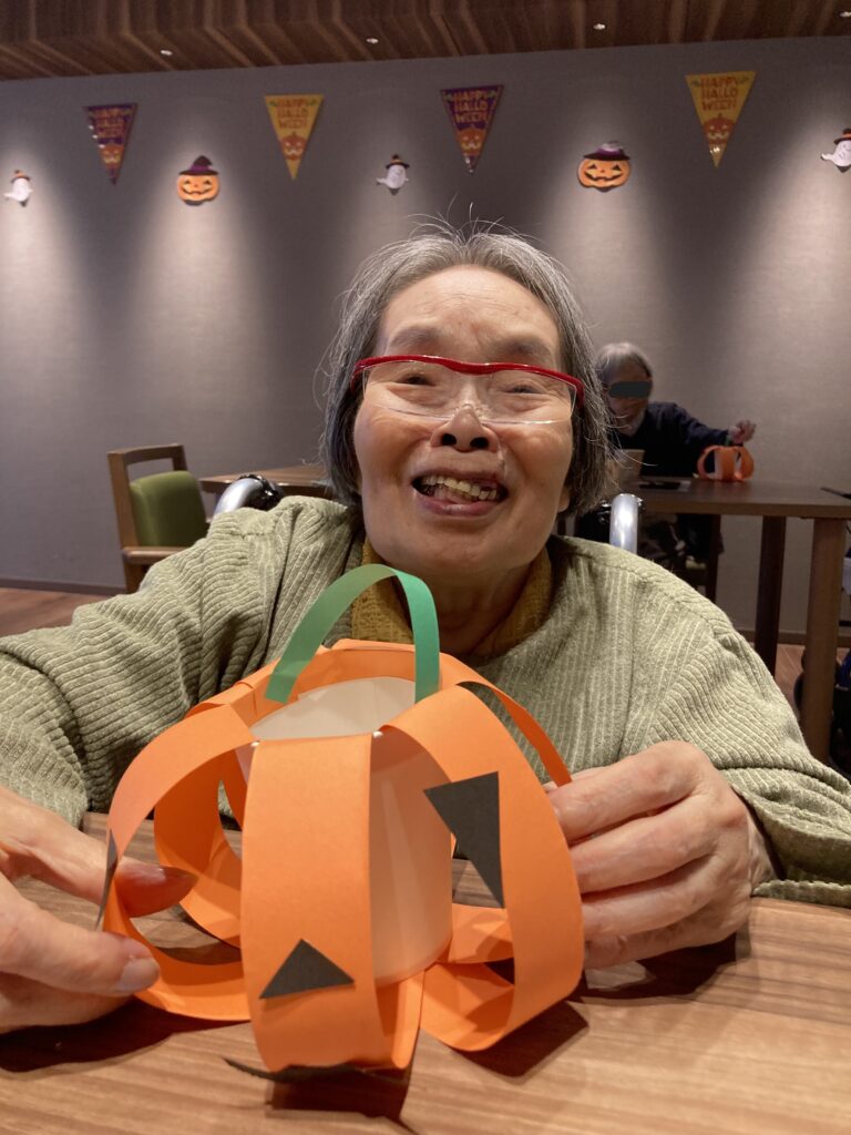 かぼちゃの飾りを持つ女性