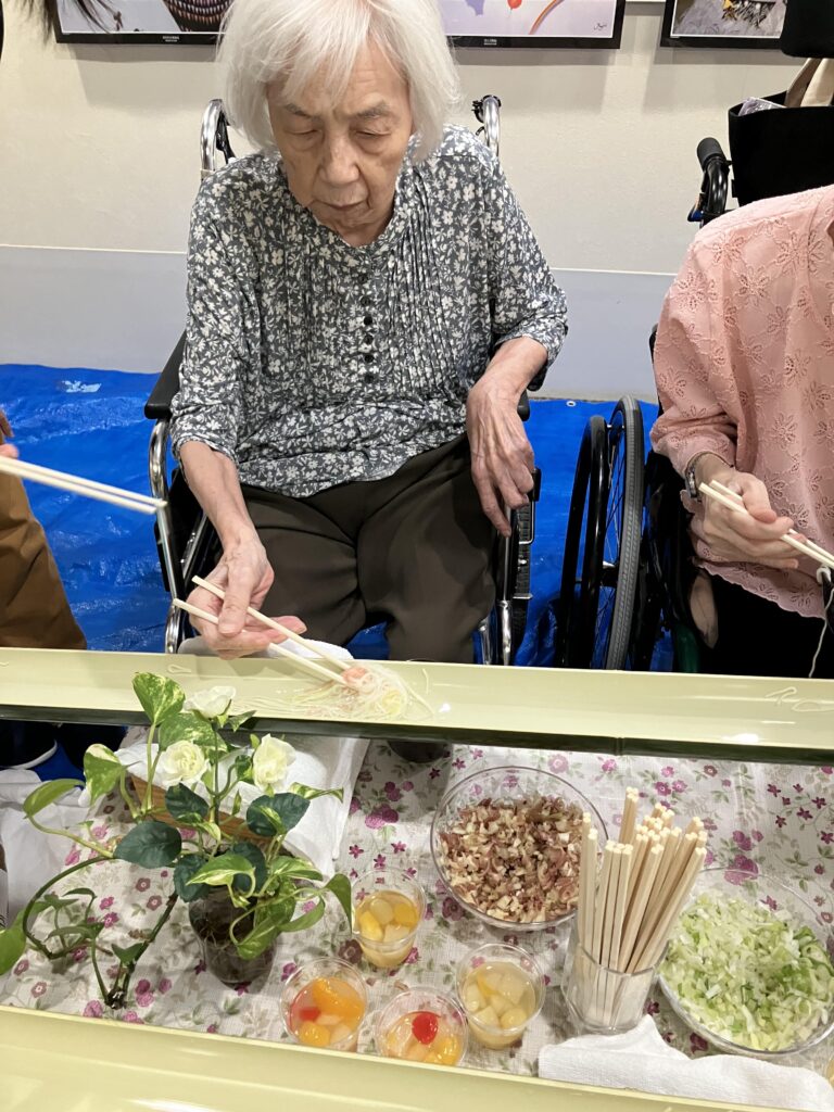 流しそうめんを食べる女性