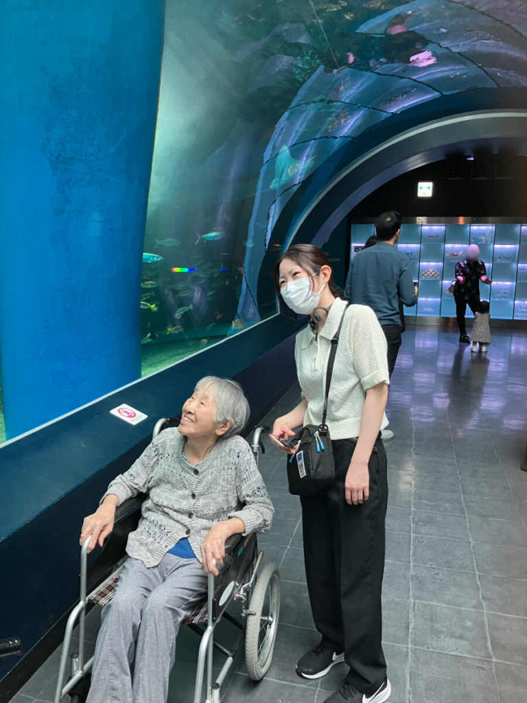 水族館で色とりどりの魚を見上げる様子