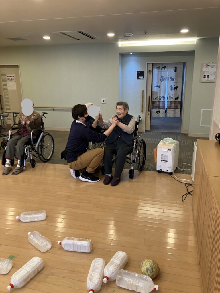 ボーリングレクリエーションでハイタッチして喜ぶご入居者