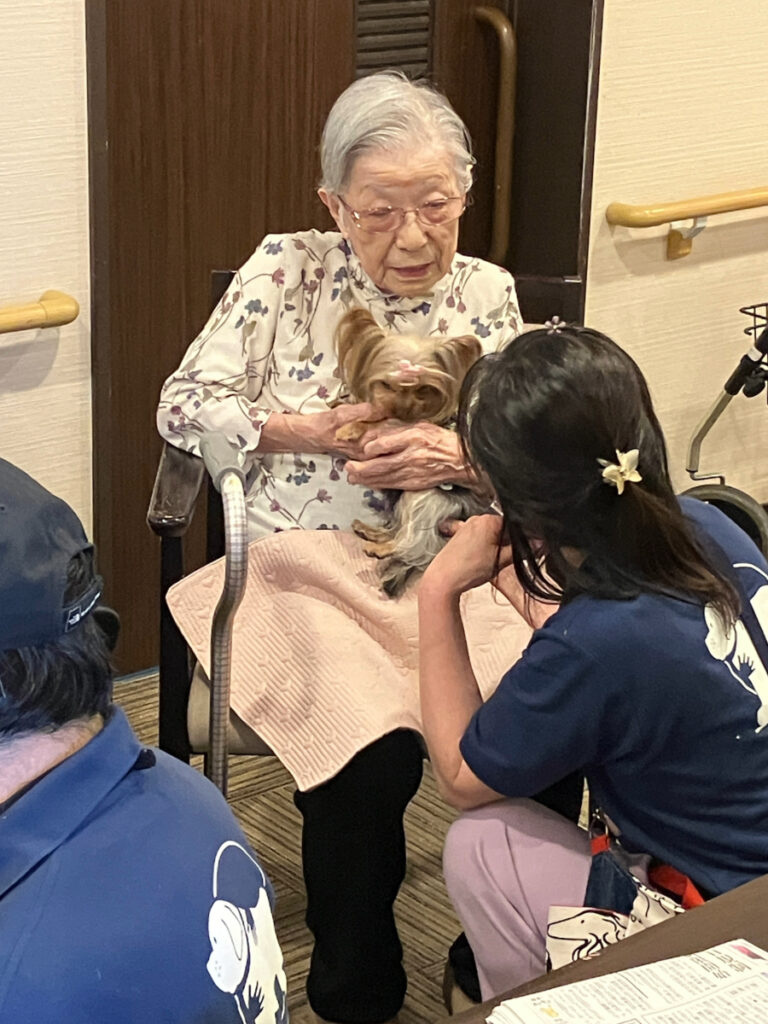 犬を膝にのせて抱くご入居者